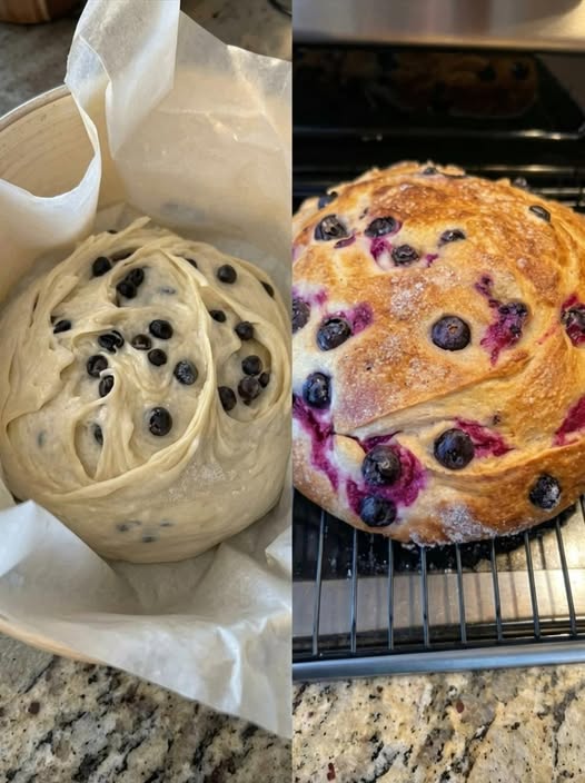 Close-up of a homemade blueberry cream cheese loaf baked in an air fryer, sliced to reveal a creamy cheesecake-like center and juicy blueberries throughout a moist golden crumb. The loaf has a lightly browned top with scattered blueberries and sits on a cooling rack beside a cup of coffee in soft natural kitchen lighting.